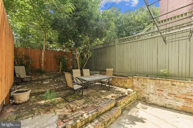 a backyard of a house with outdoor seating