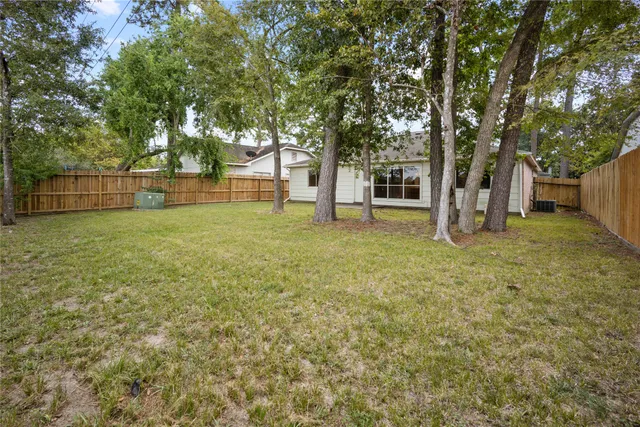 a view of a yard with a house and large tree