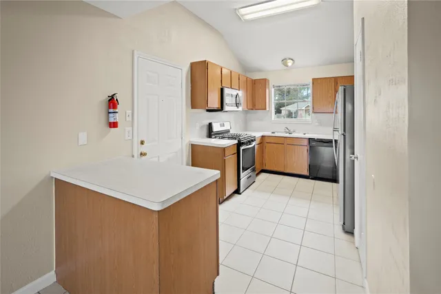 a kitchen with a sink cabinets and stainless steel appliances