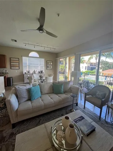 a living room with furniture and a floor to ceiling window