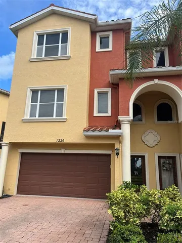 a kitchen with stainless steel appliances wooden cabinets a stove a sink and a refrigerator