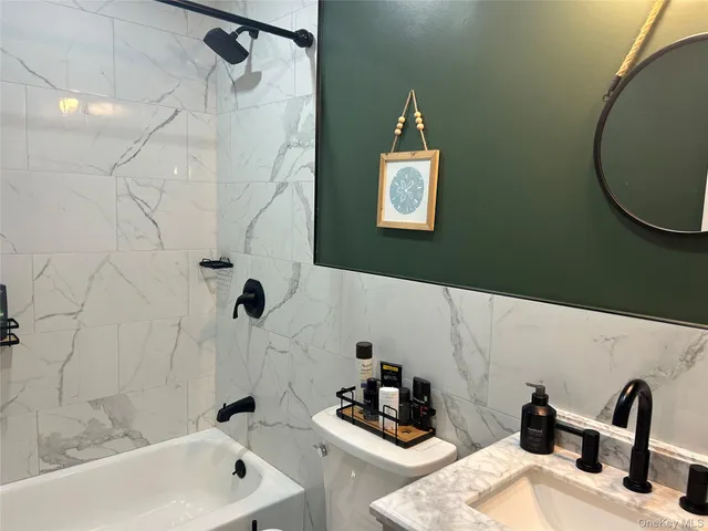 a bathroom with a sink a bathtub and a shower