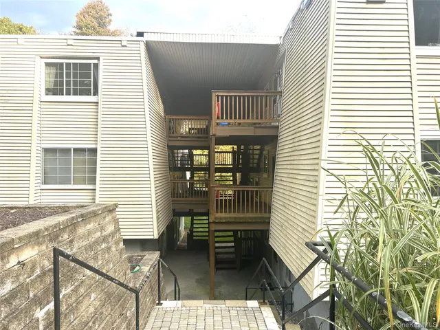 a balcony with furniture and wooden floor