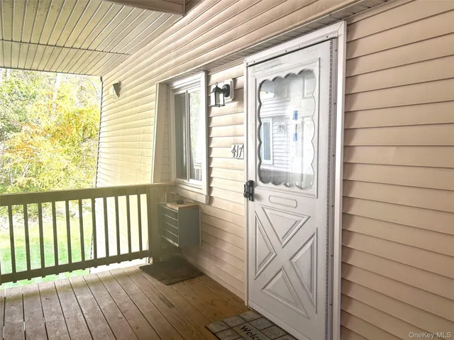 a view of a porch with wooden floor and deck
