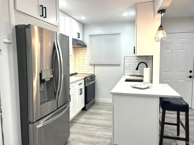 a kitchen with a refrigerator sink and stove