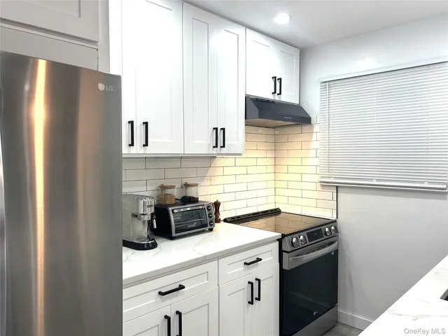 a kitchen with a sink and a refrigerator