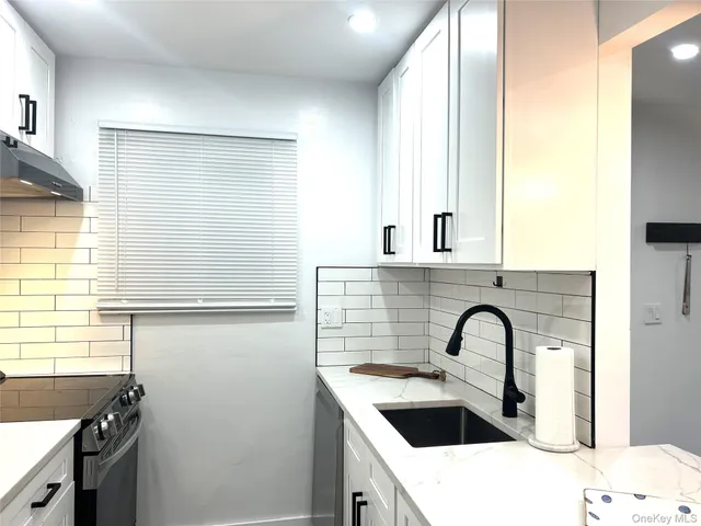 a kitchen with a refrigerator and a sink