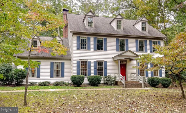a aerial view of a house with yard and green space
