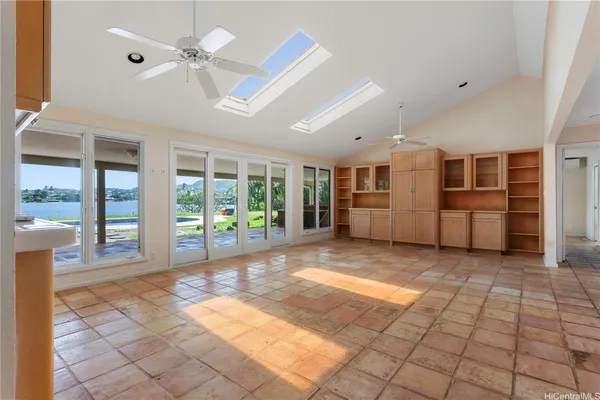 a view of a livingroom with furniture an entryway front door and windows