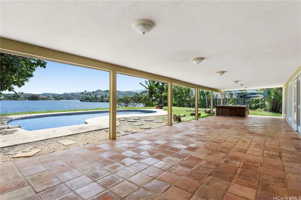 a view of a house with backyard and a patio
