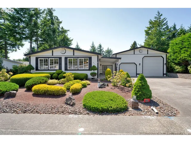a front view of a house with a garden and patio
