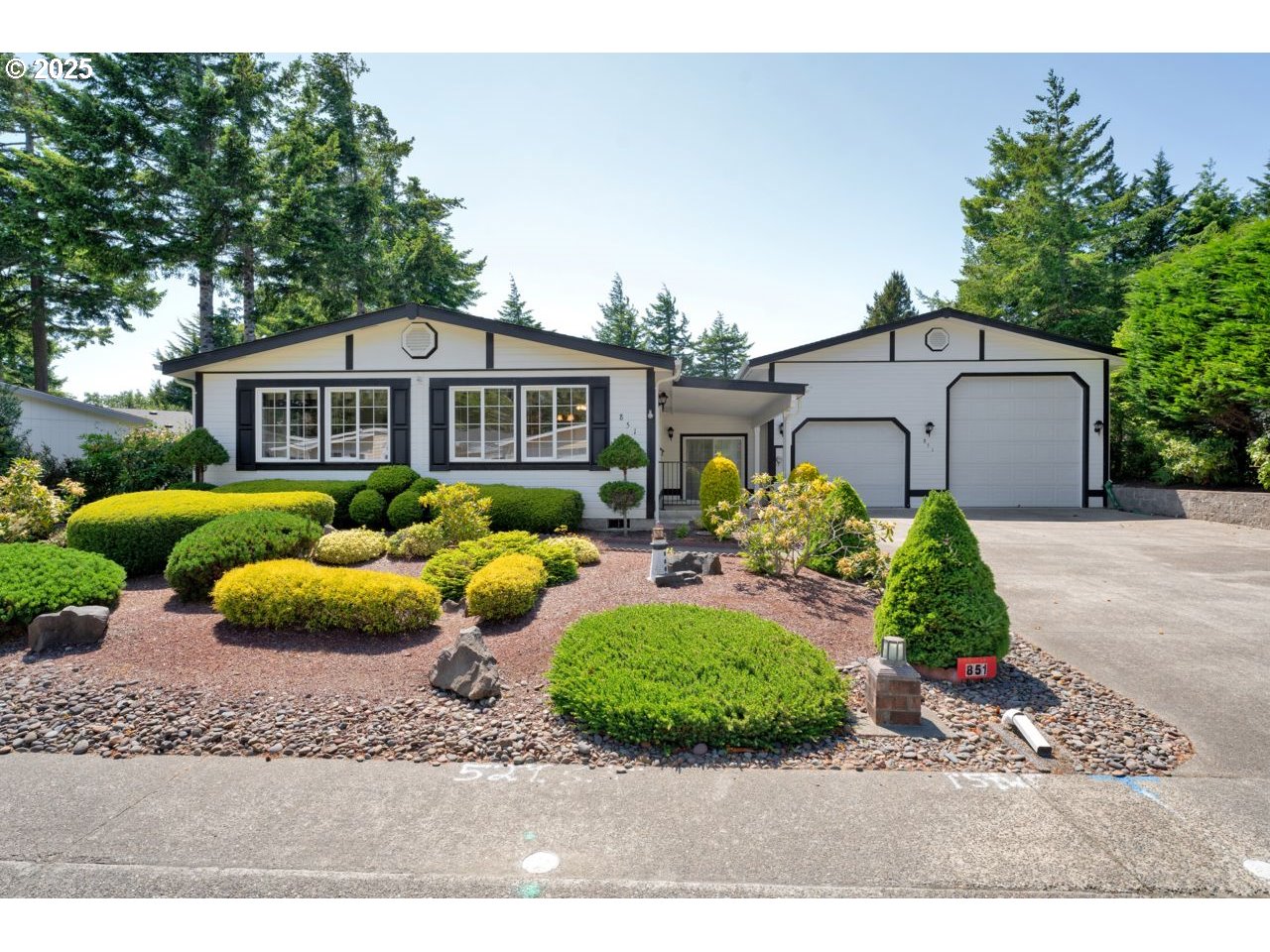 a front view of a house with a garden and patio