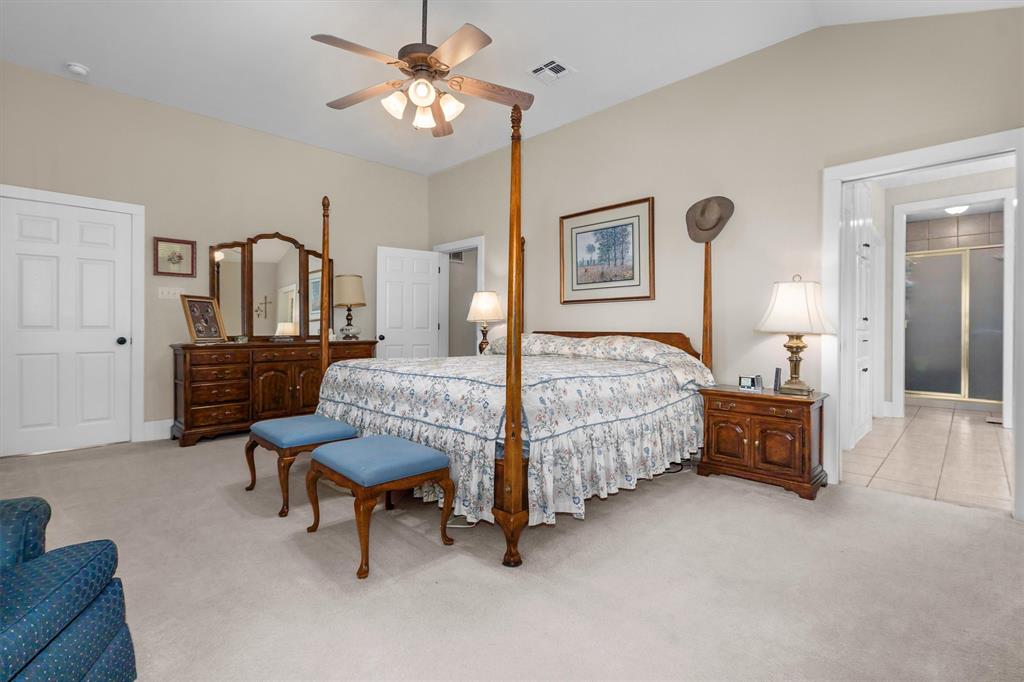 810 East Fm 321 Palestine, TX 75803 - Photo 17 of 40 a bedroom with a bed a chandelier and dresser