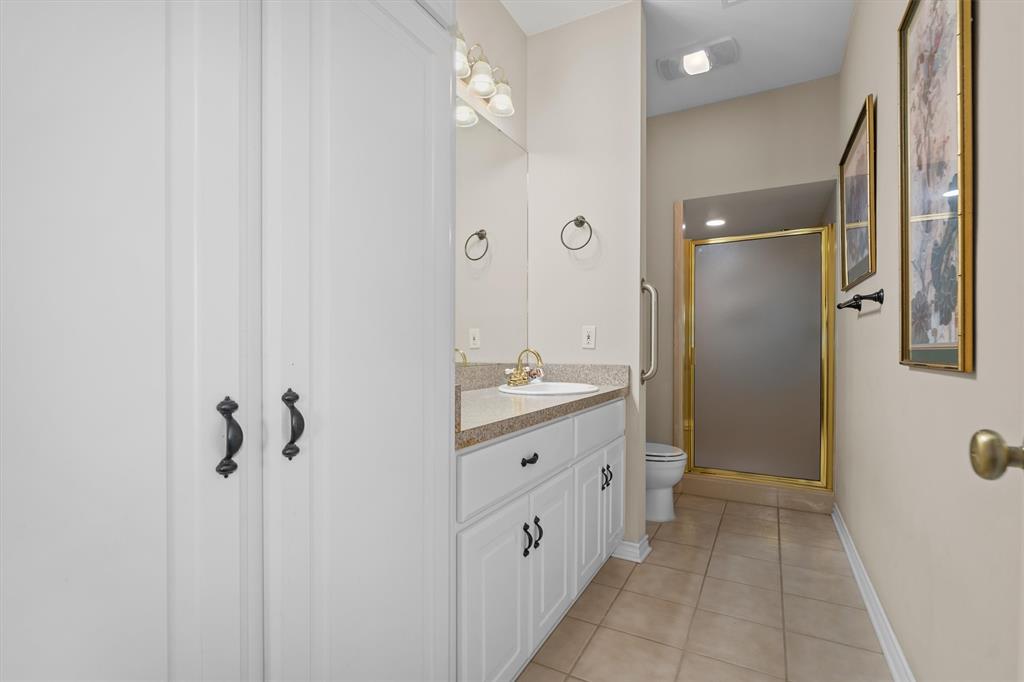 810 East Fm 321 Palestine, TX 75803 - Photo 26 of 40 a bathroom with a double vanity sink a mirror and a shower