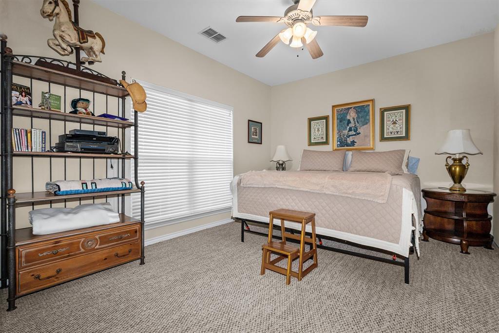 810 East Fm 321 Palestine, TX 75803 - Photo 29 of 40 a bedroom with a bed and a chandelier