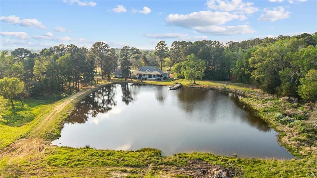 810 East Fm 321 Palestine, TX 75803 - Photo 4 of 40 a view of a lake with a yard and mountain in the back