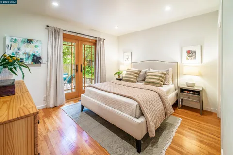 a spacious bedroom with a bed and a dresser