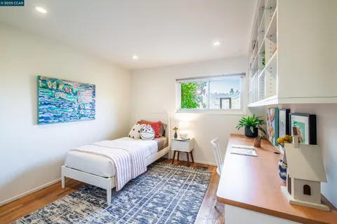 a living room with furniture and a painting on the wall