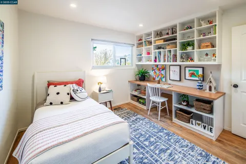 a bedroom with a bed and a book shelf