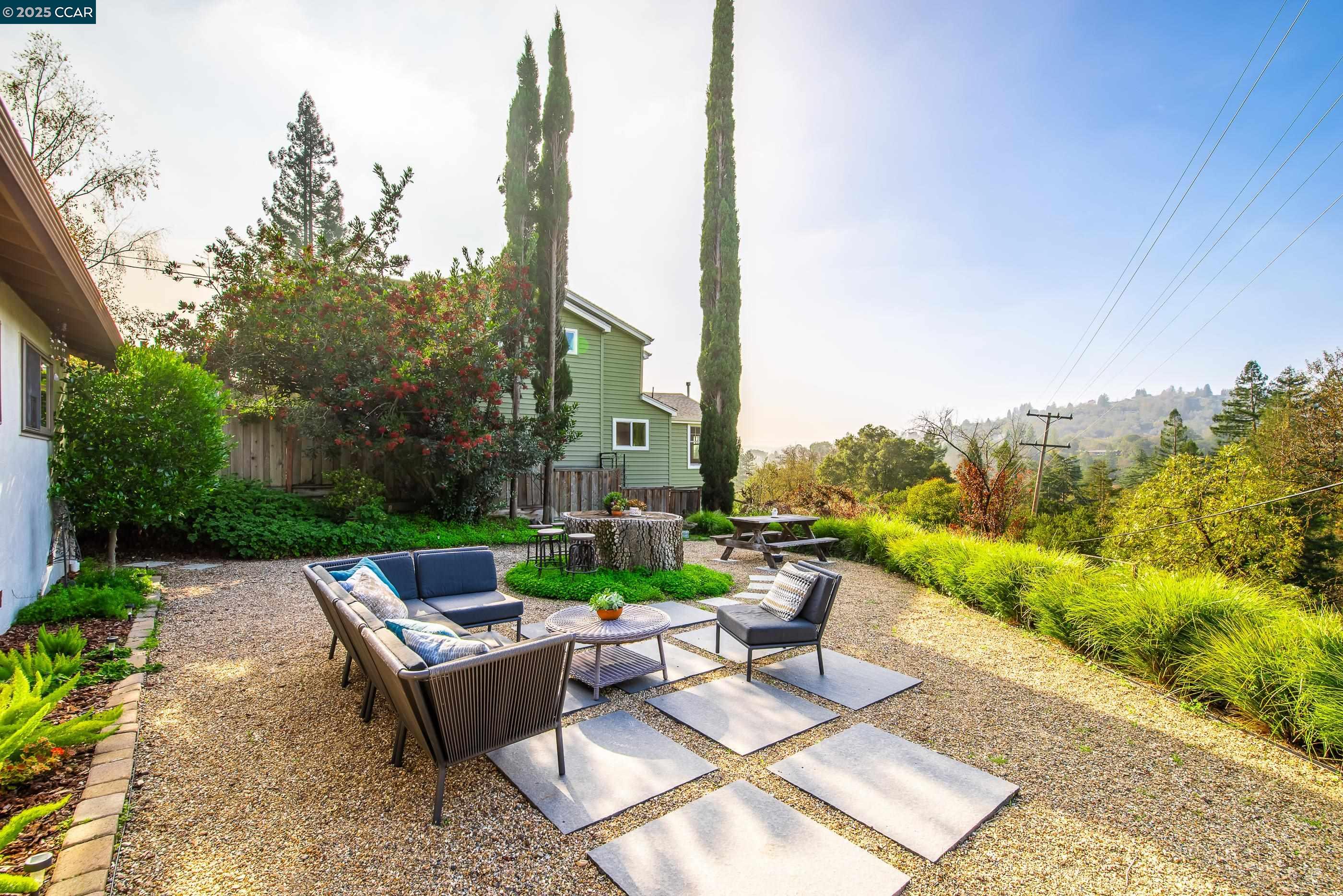1085 Oak Hill Road, Unit D Lafayette, CA 94549 - Photo 31 of 35 a view of a patio with couches table and chairs next to yard