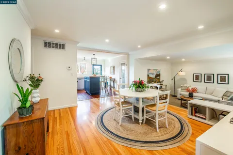 a living room with furniture and a dining table