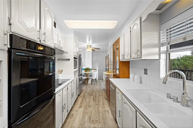 a kitchen with a sink stove and cabinets