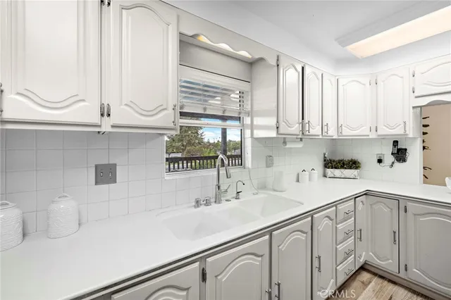 a kitchen with appliances a sink and cabinets