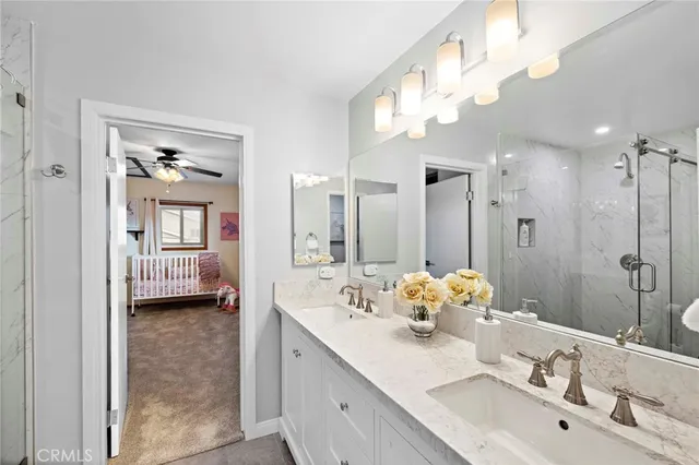 a bathroom with a double vanity sink mirror and double