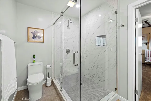 a bathroom with a toilet a sink and shower