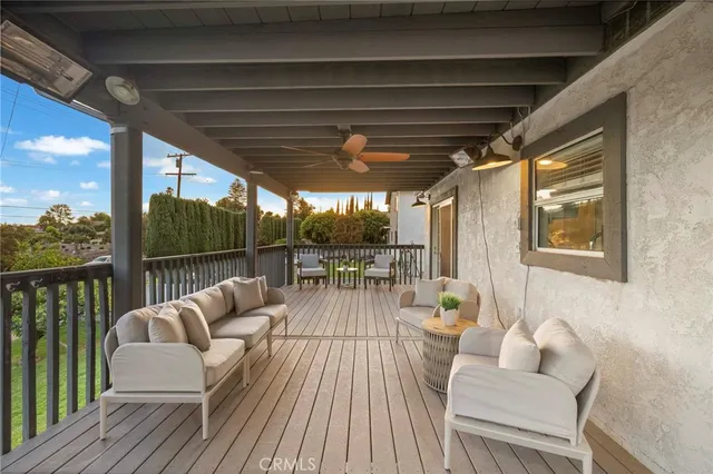 a balcony with couch and chairs