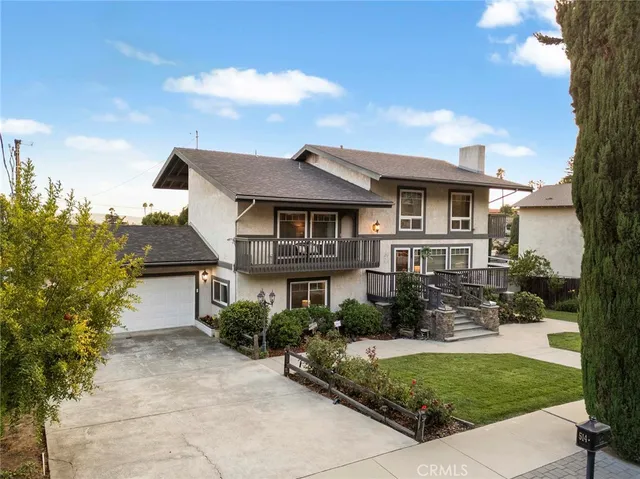 a front view of a house with a garden