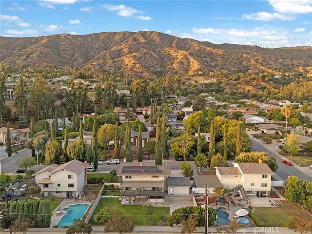 an aerial view of residential houses with city view