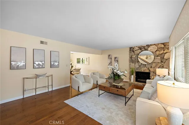 a living room with furniture a fireplace and a table