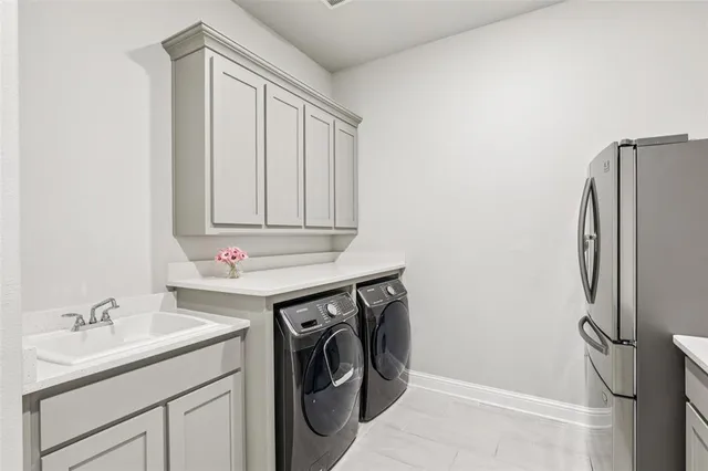 a utility room with a sink a washer and dryer