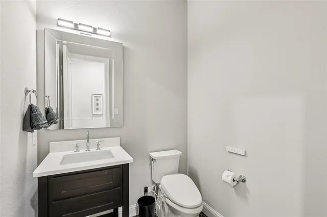 a bathroom with a sink a toilet and mirror