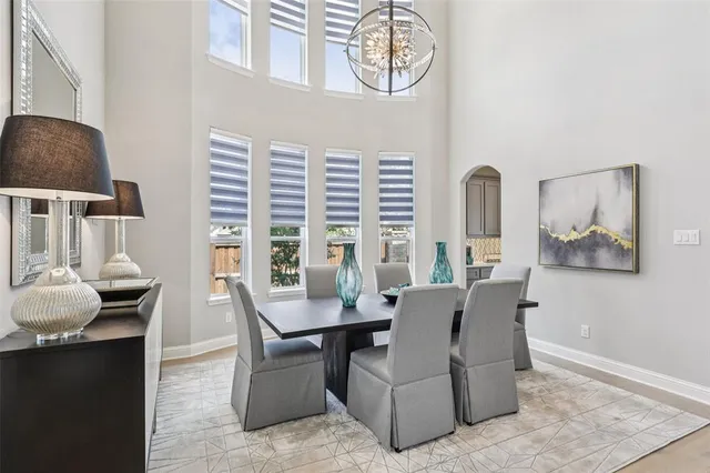 a dining room with furniture and wooden floor