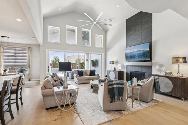 a living room with fireplace furniture and a large window