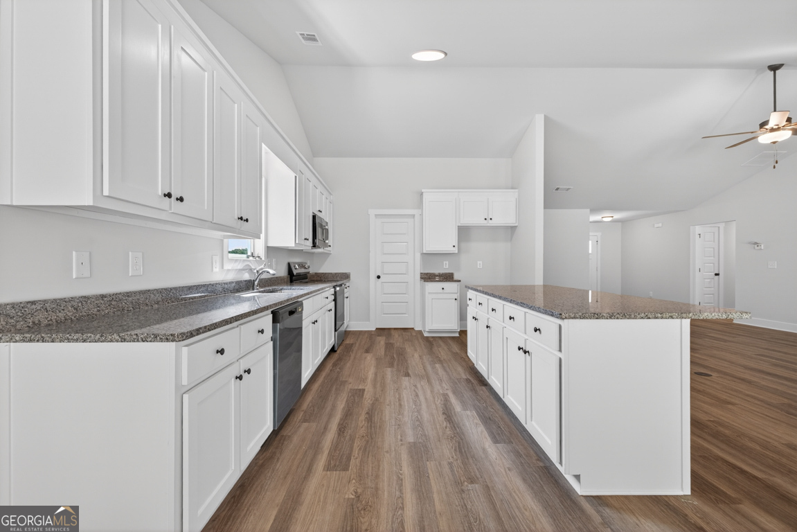 206 Airport Road, Unit 11 Canon, GA 30520 - Photo 11 of 34 a large kitchen with granite countertop a lot of counter space and wooden floor