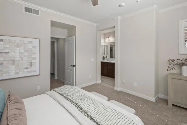 a bedroom with a bed and a painting on the wall