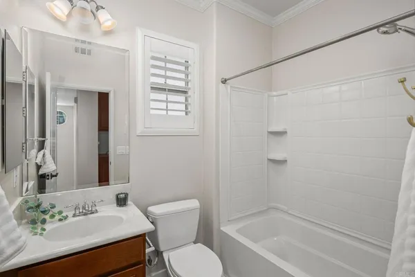 a bathroom with a sink toilet a mirror and shower