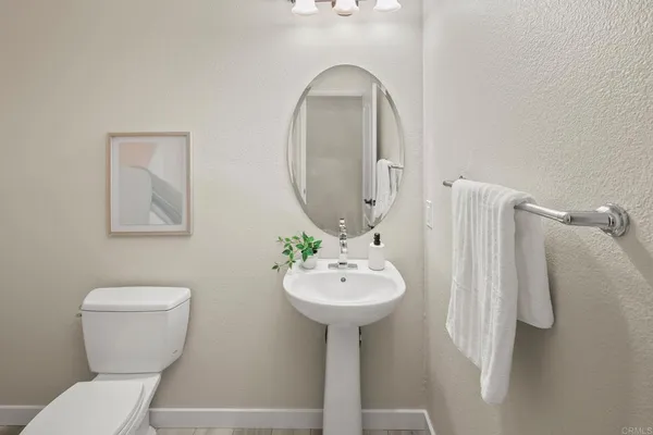 a bathroom with a sink toilet and a mirror