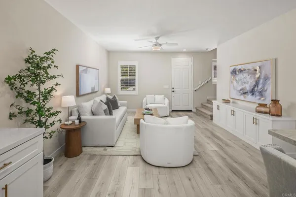 a living room with furniture and flowers
