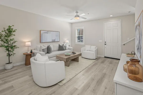 a living room with furniture and a wooden floor