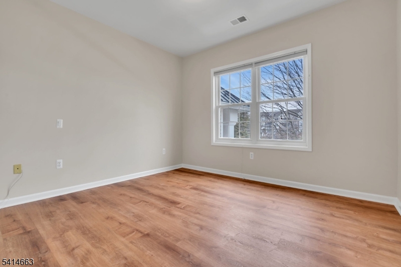 7204 Westover Way, Unit 7204 Somerset, NJ 08873 - Photo 23 of 43 a view of an empty room with a window and a painting on the wall