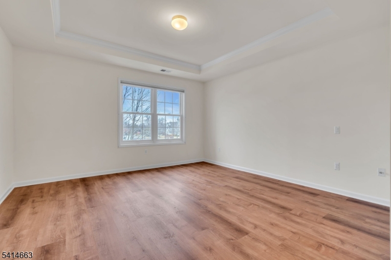 7204 Westover Way, Unit 7204 Somerset, NJ 08873 - Photo 32 of 43 an empty room with wooden floor and windows