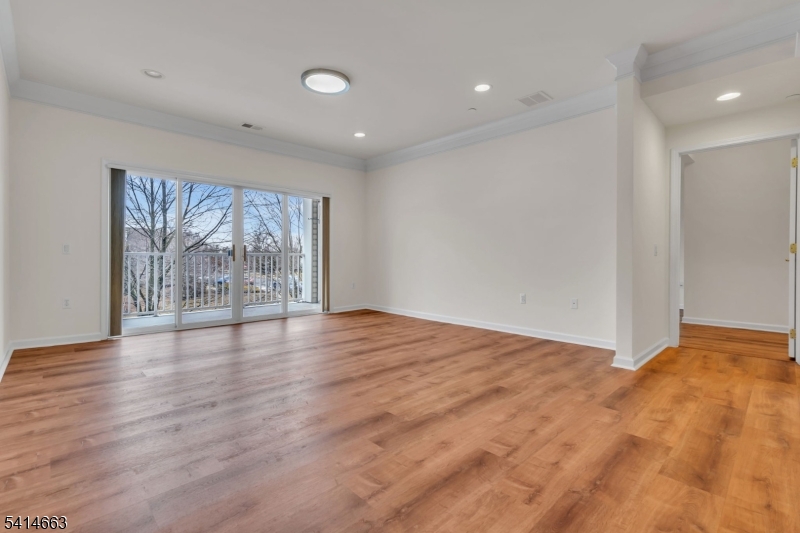 7204 Westover Way, Unit 7204 Somerset, NJ 08873 - Photo 10 of 43 a view of an empty room with wooden floor and a window