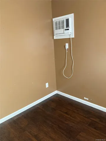 a view of a room with wooden floor and windows