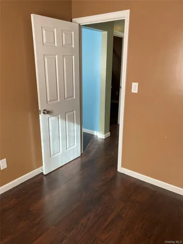 an empty room with wooden floor