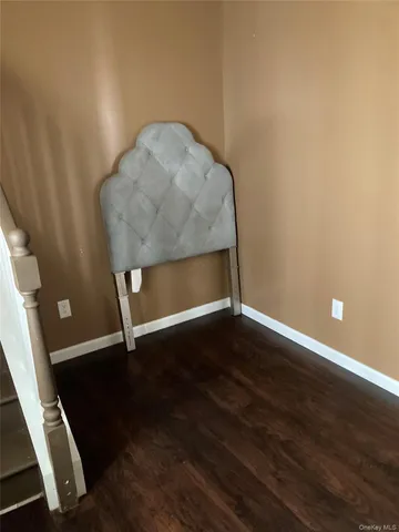 a room with wooden floor and lounge chair
