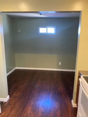 a view of room with wooden floor and windows